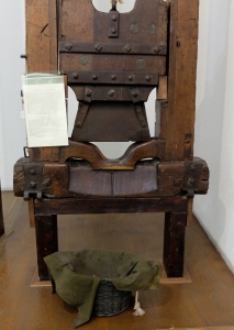 a guillotine with moth eaten basket